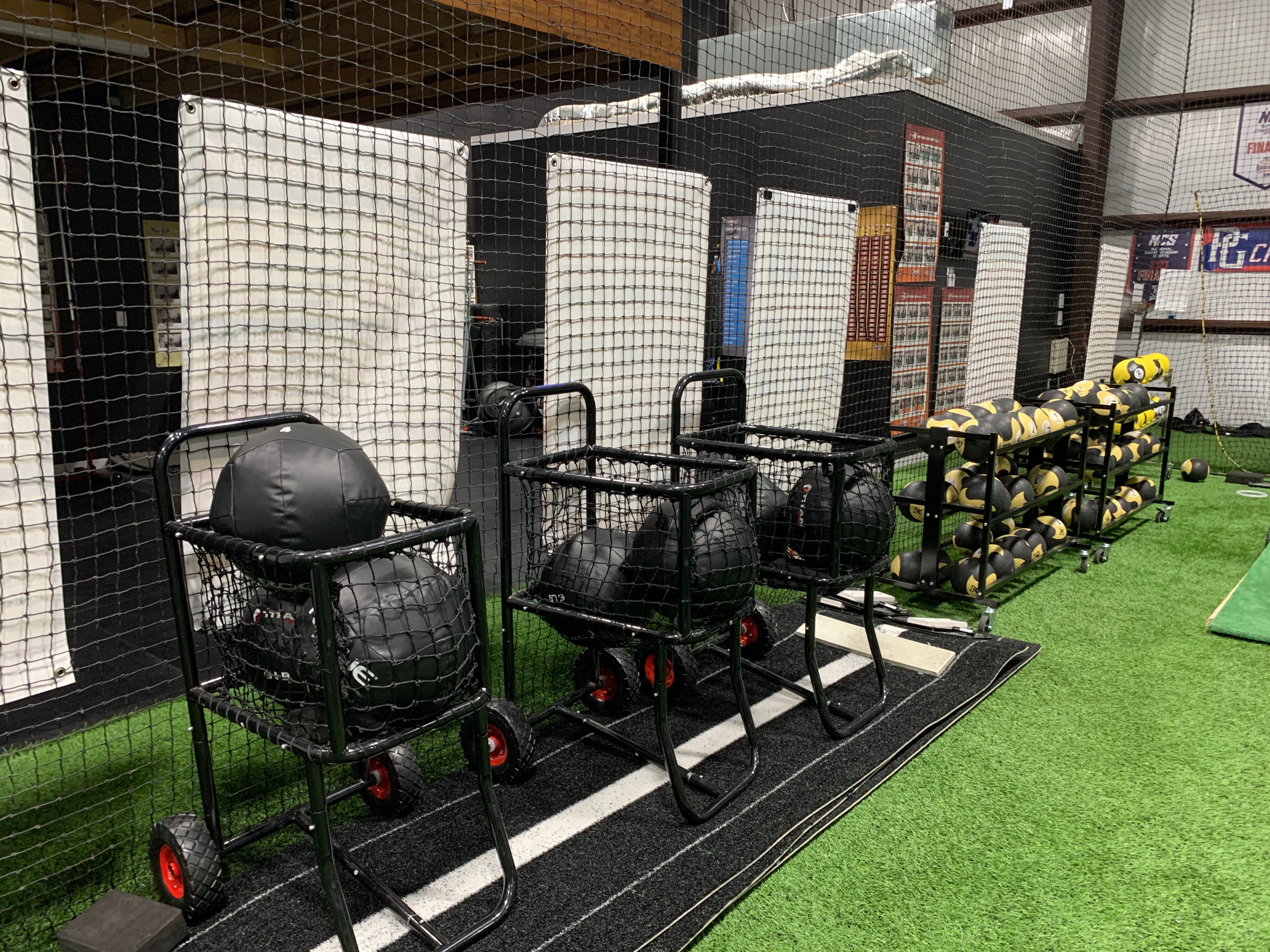 Indoor baseball batting cages at Train Station Baseball Academy in Argyle, TX — 8 full-size lanes with turf and netting