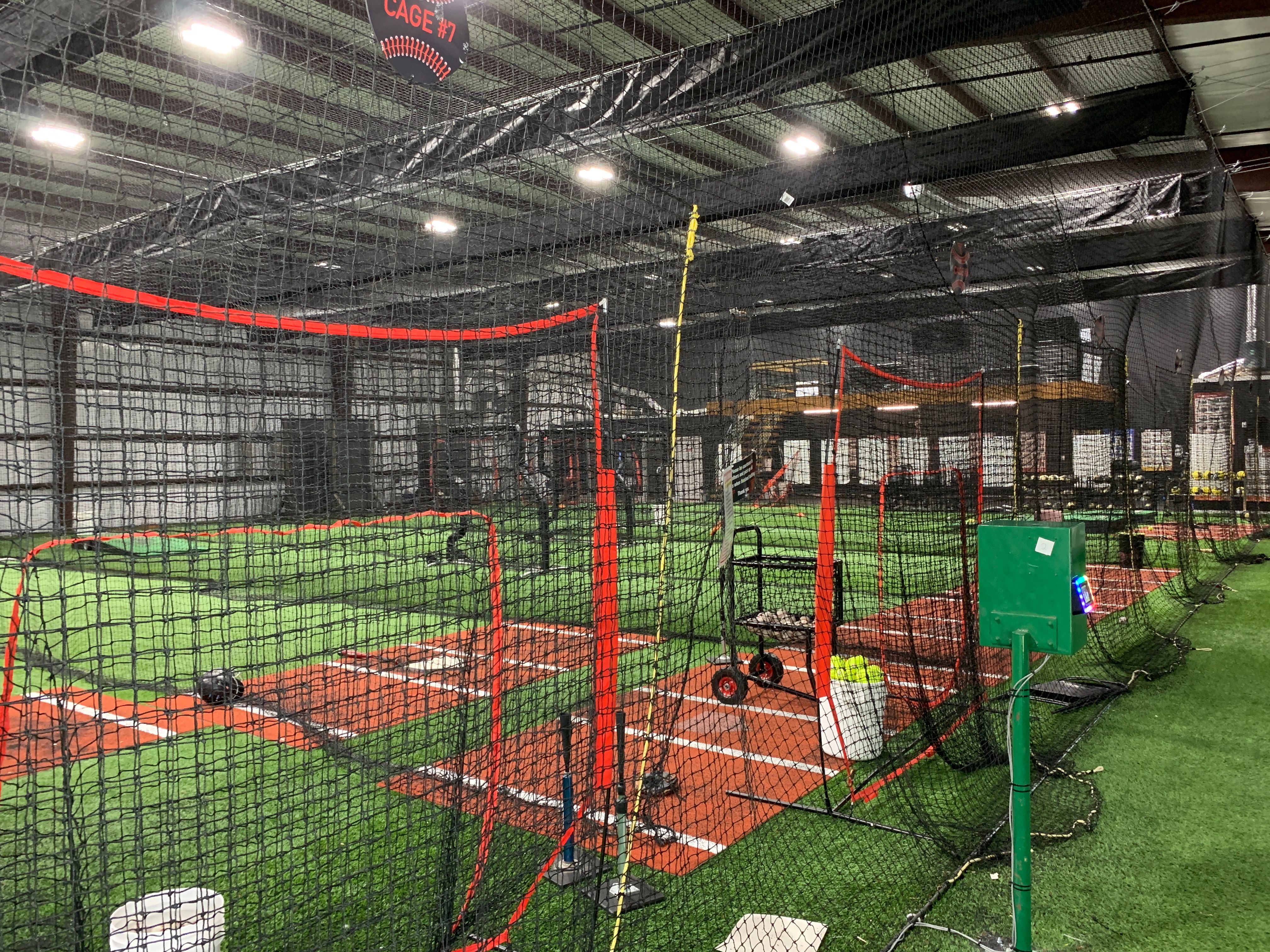 HitTrax batting analysis machine and pitching machine controller inside Train Station Baseball Academy — Top Velocity certified training facility in Argyle, TX